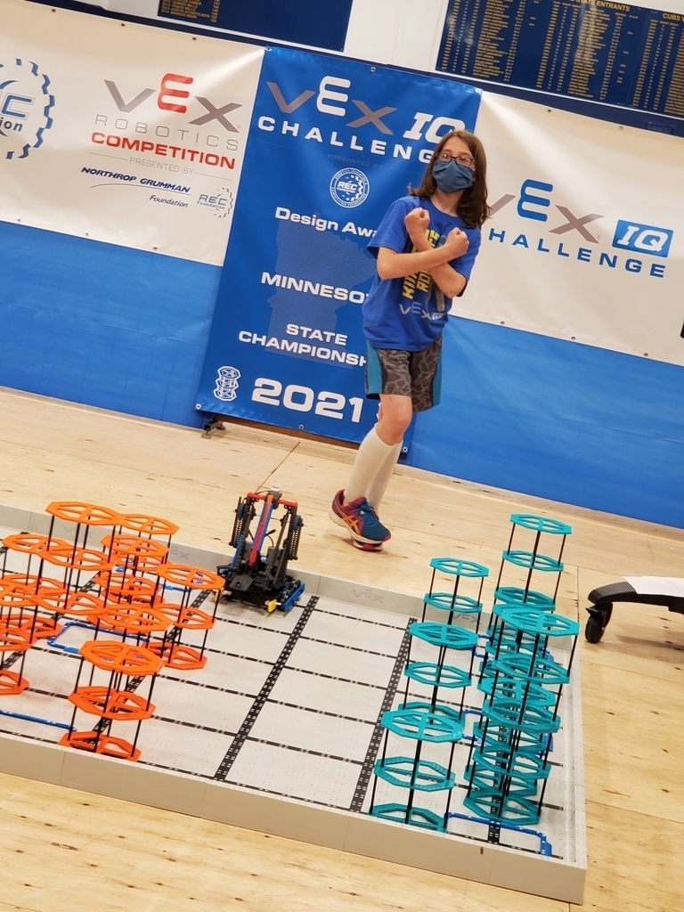 Student poses with robot